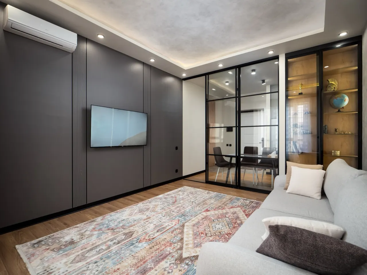 Smart TV wall beside the glass partition