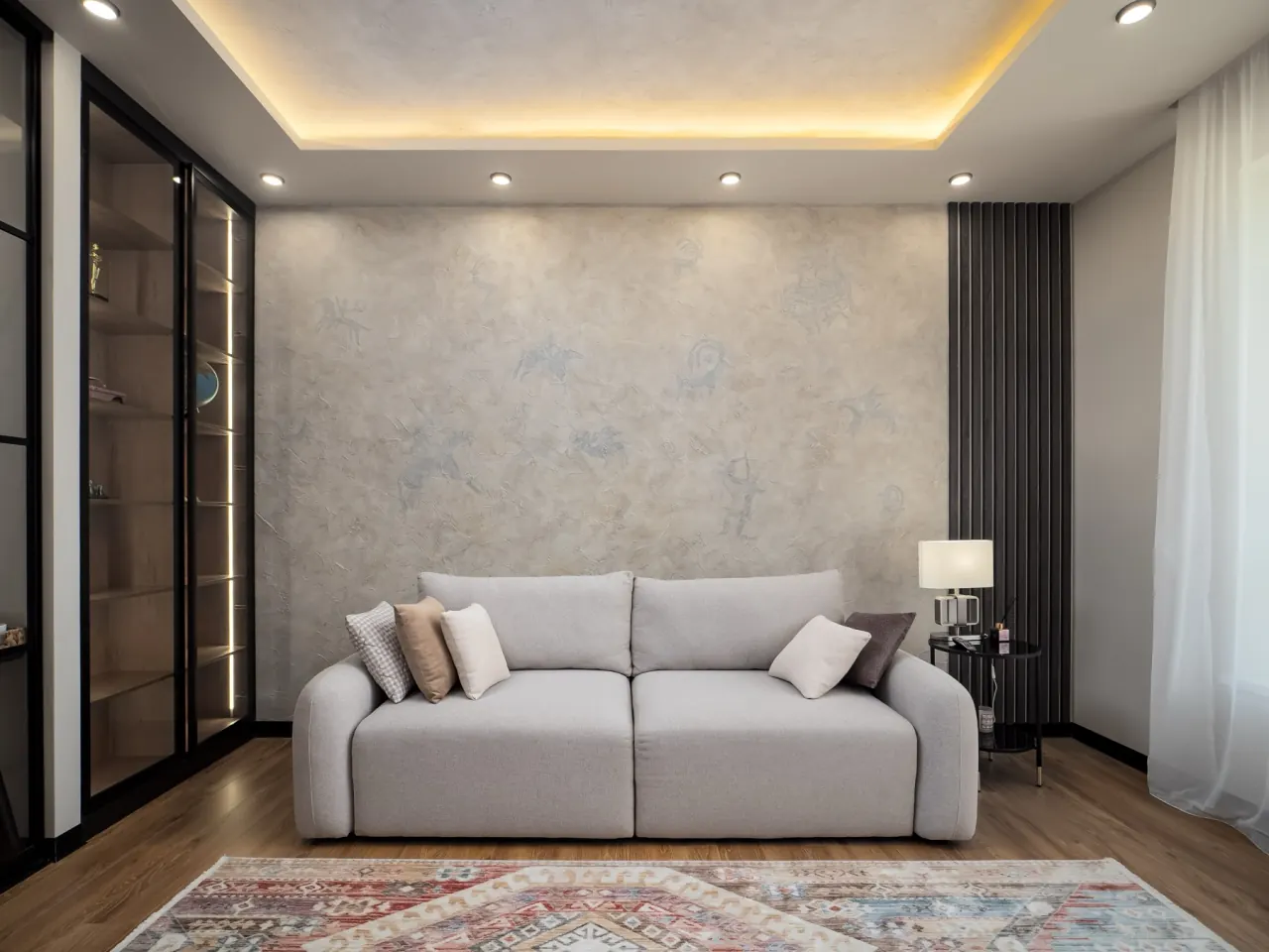 Deep three-seat sofa against a panelled wall