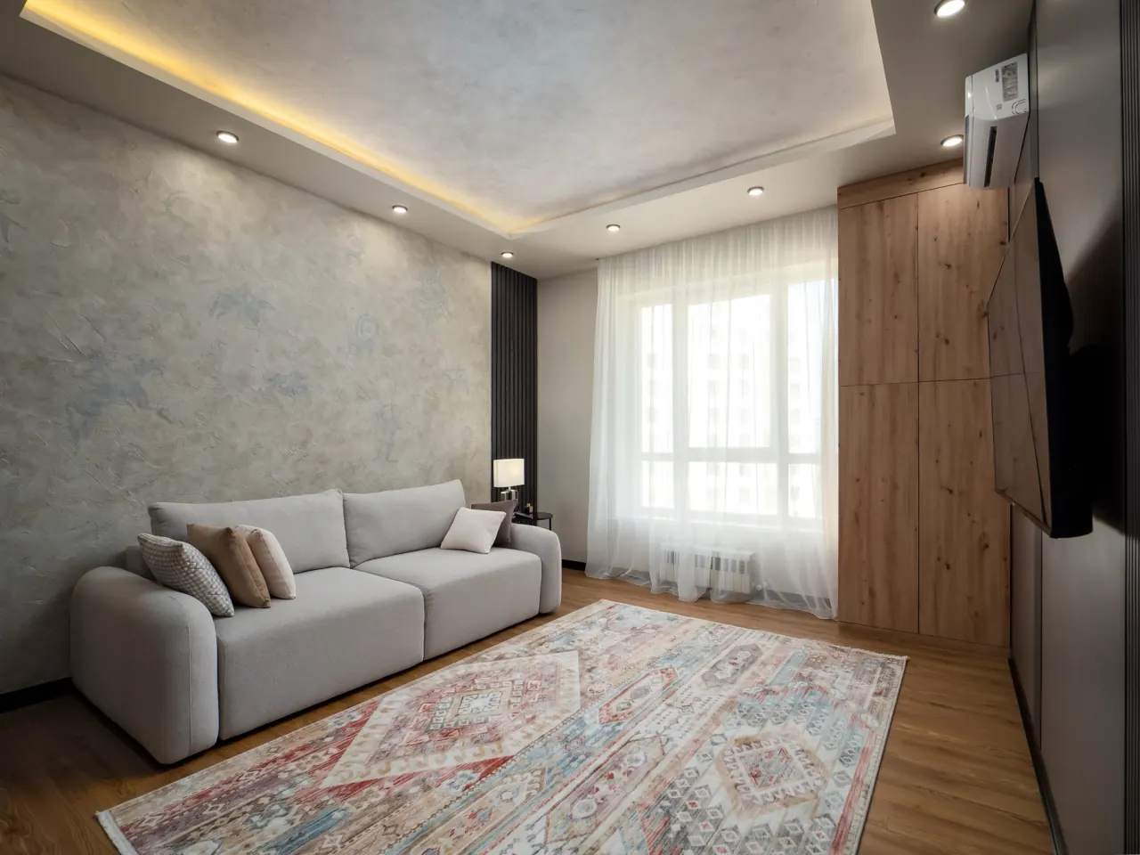 Sofa by the window with sheer curtains
