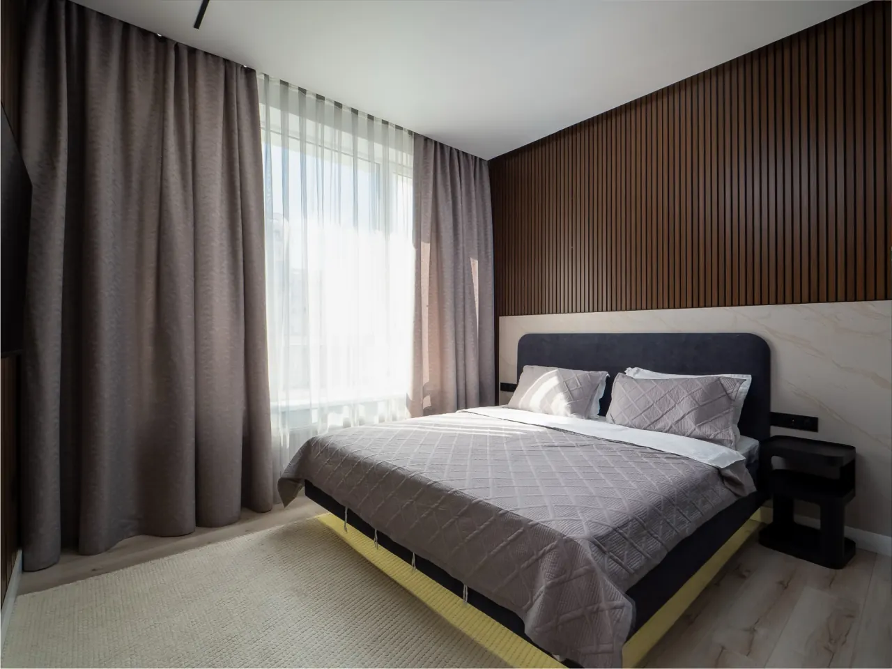 Bedroom with walnut slat headboard wall