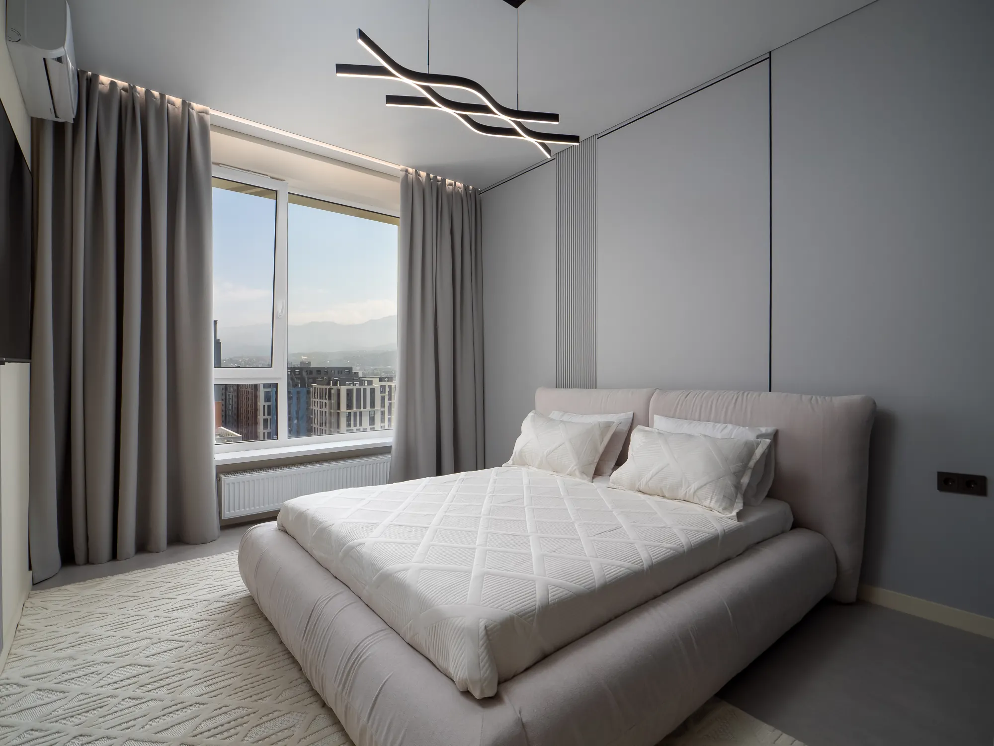 King-size bed with soft upholstered headboard