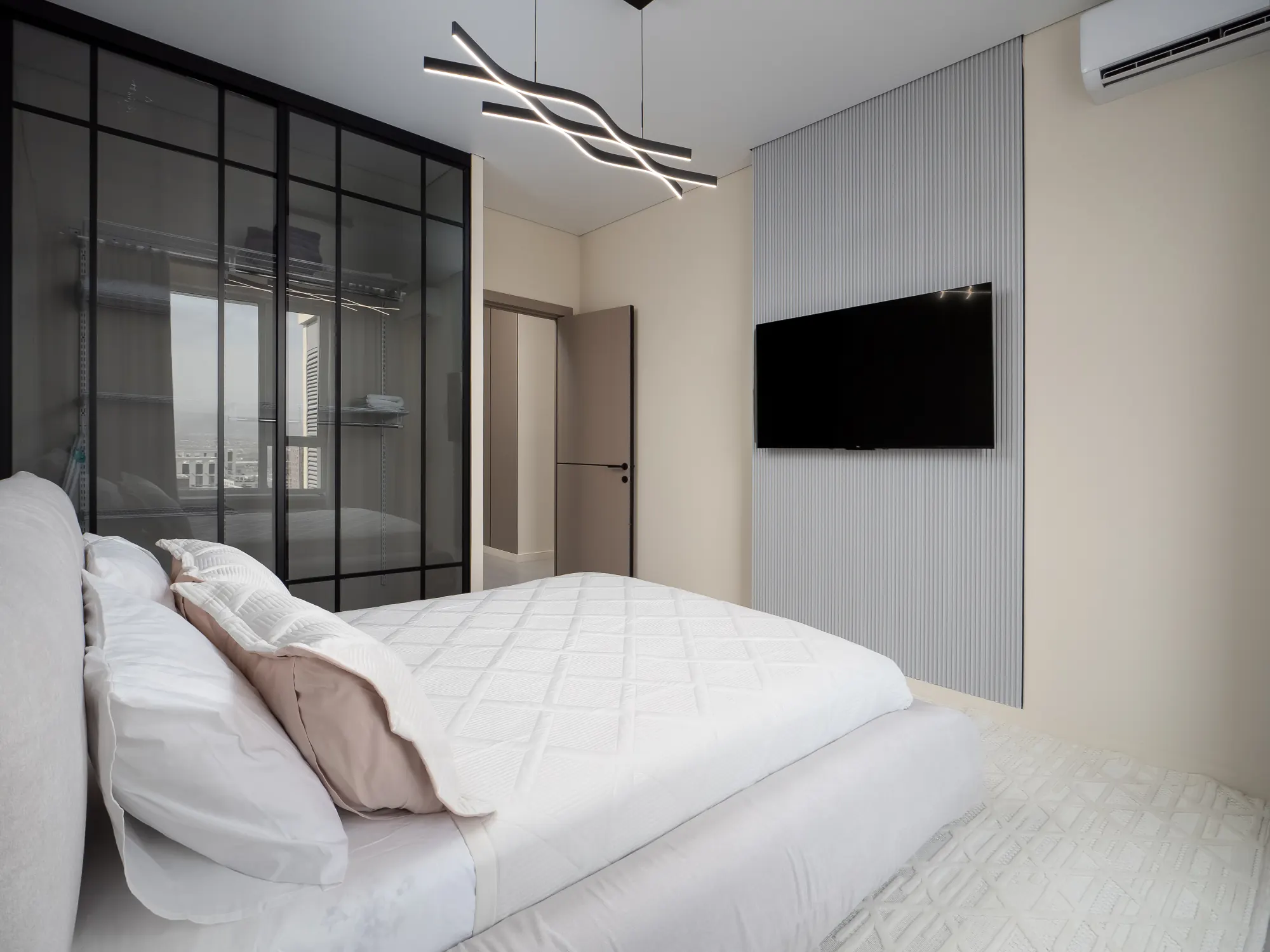 Sleeping area with glass partition and television