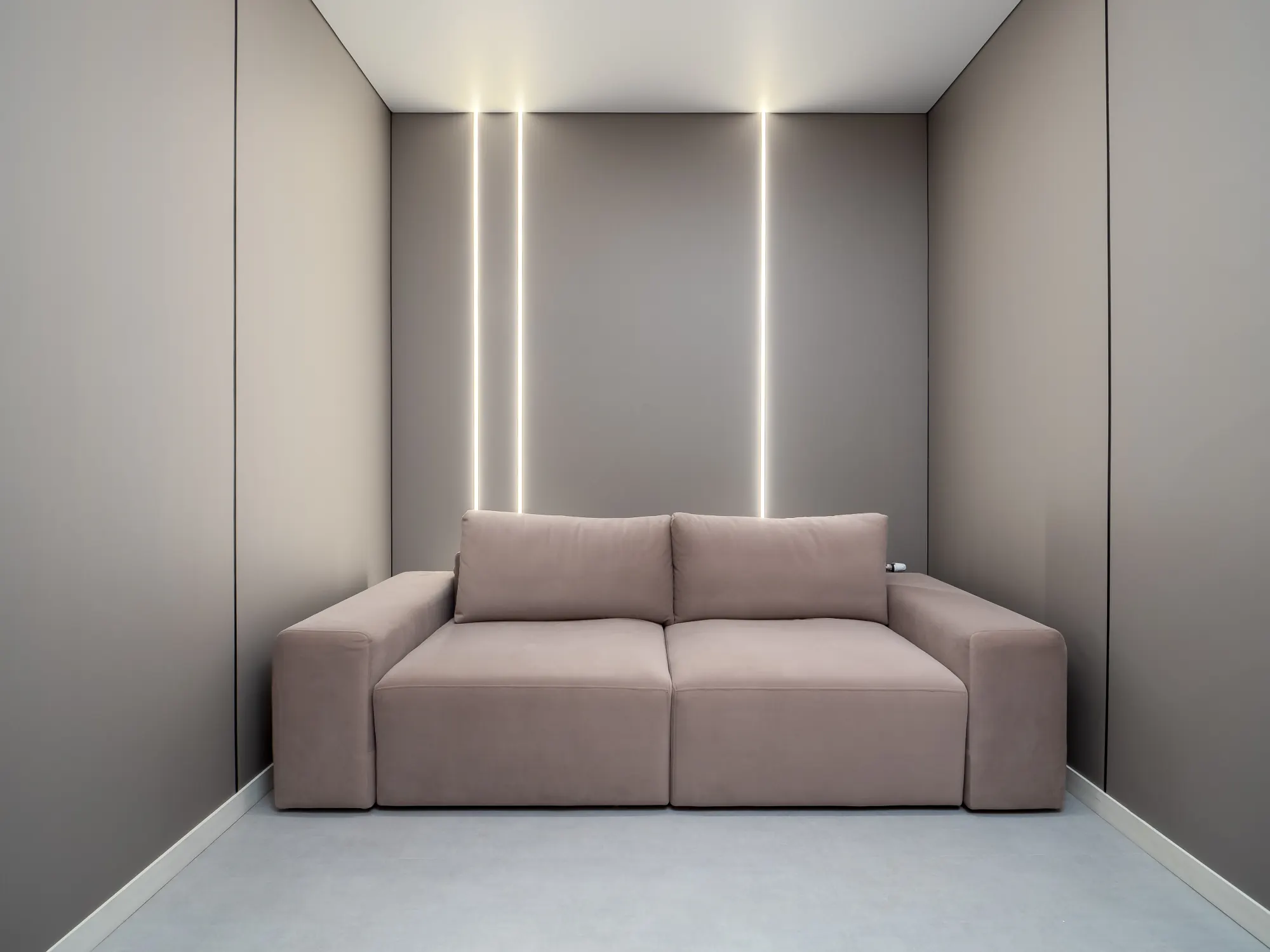 Blush sofa framed by recessed lighting