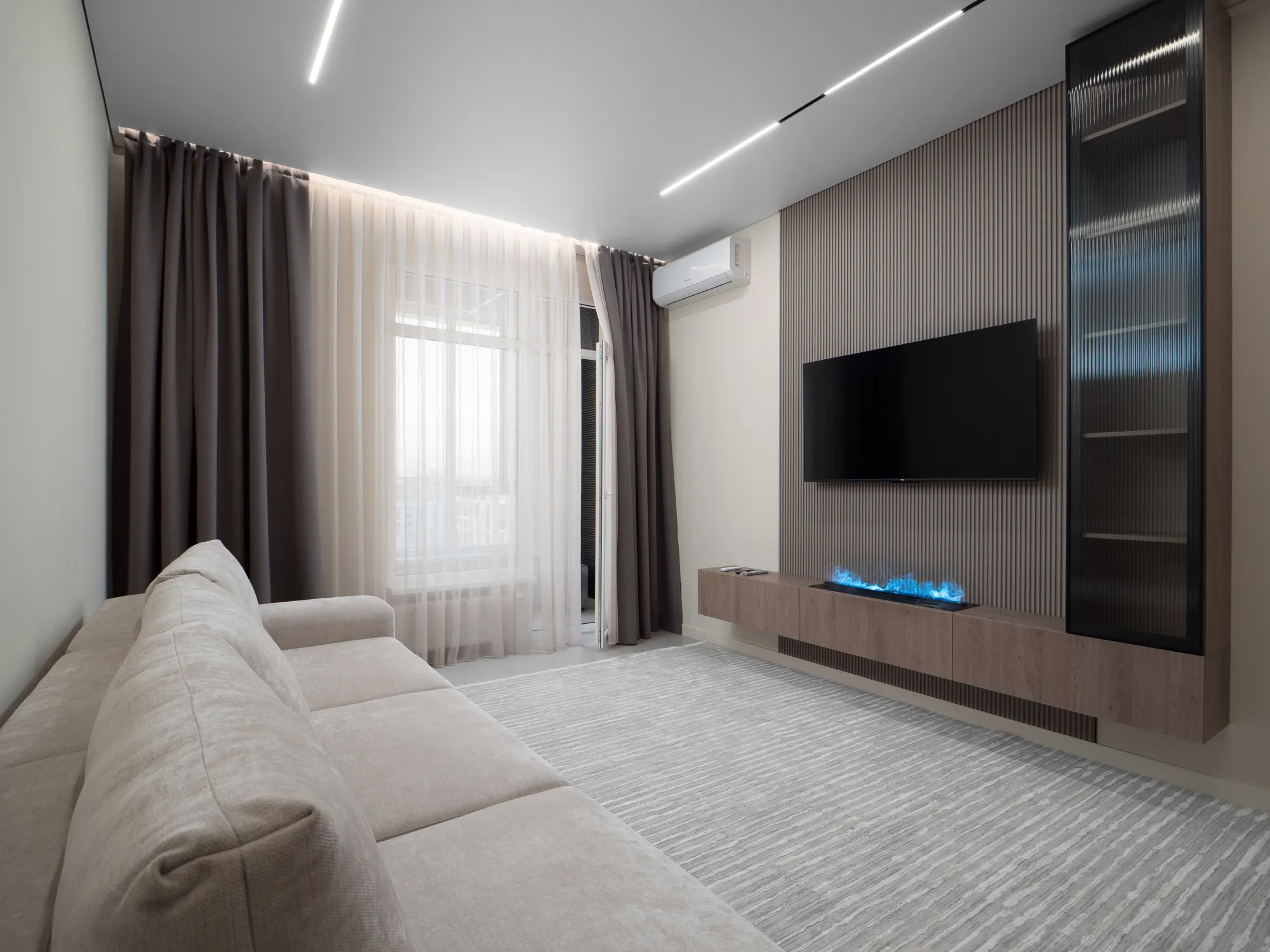 Media wall with fluted glass cabinetry