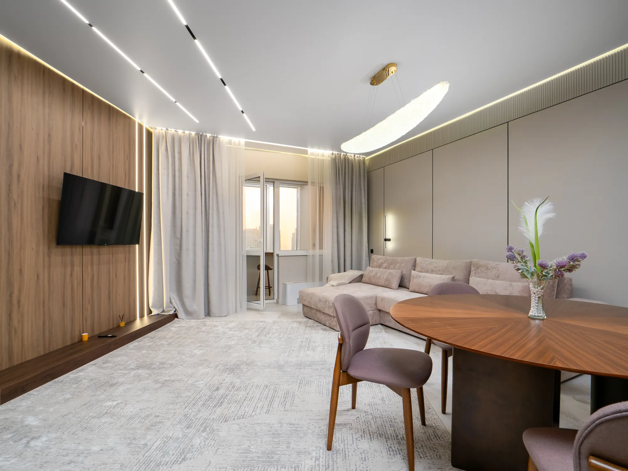 Living room with walnut slat wall and round dining table