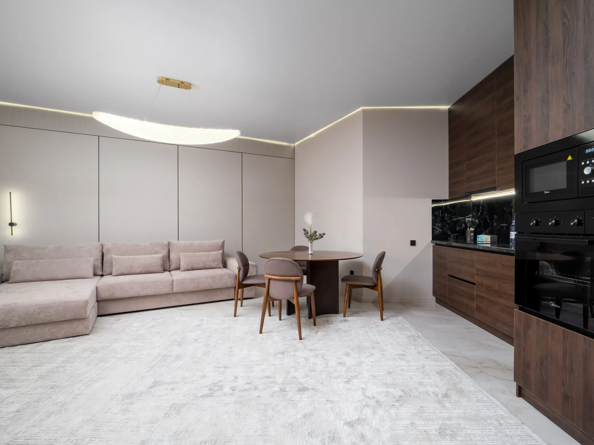 Open living and kitchen area in soft blush tones