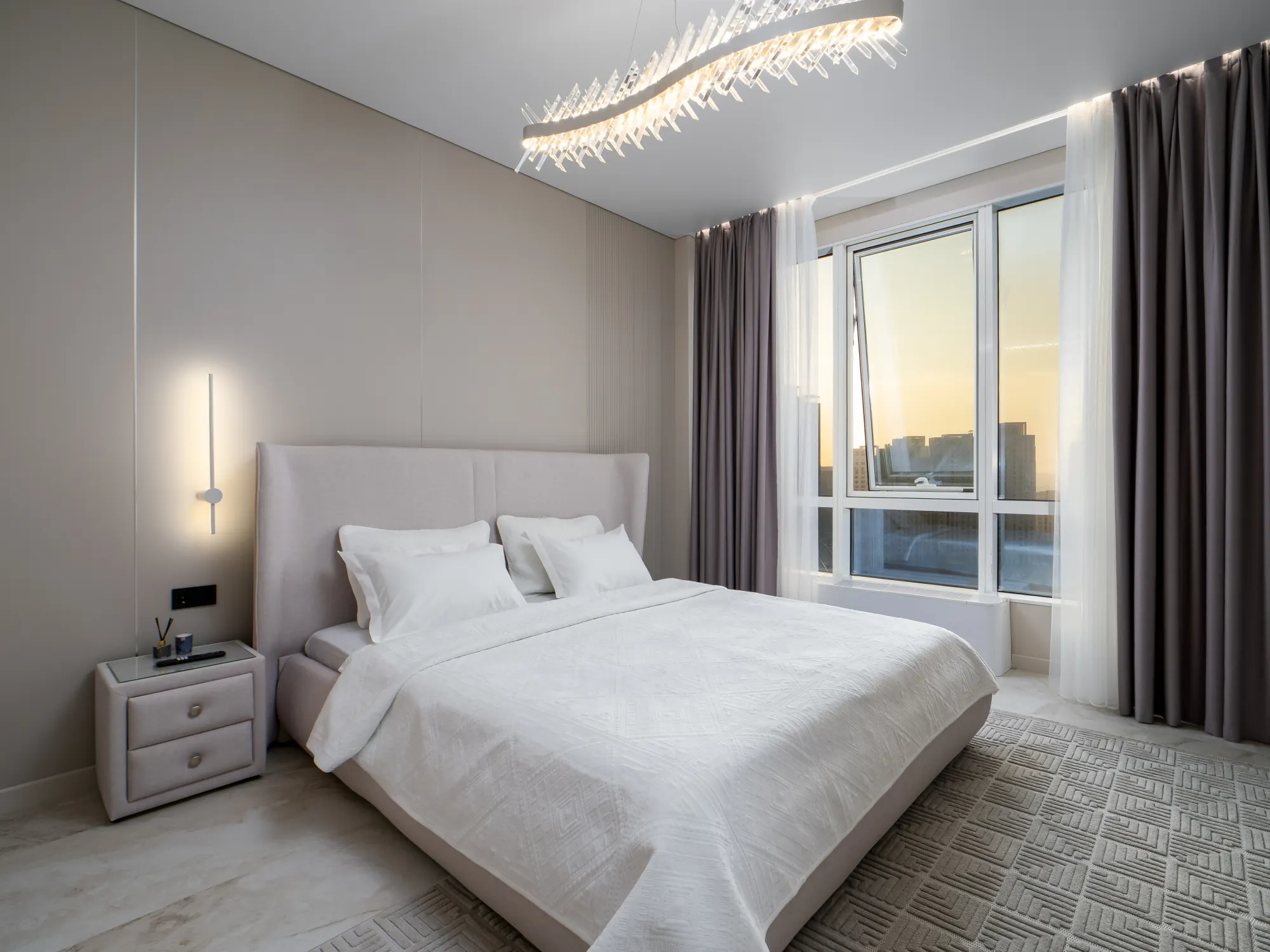 Bedroom at sunrise with city views