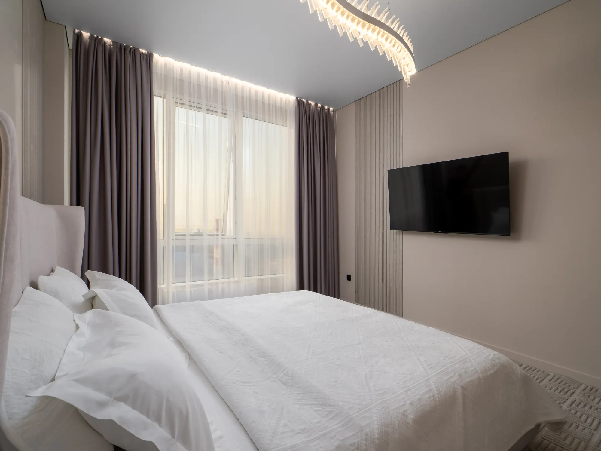 Bedroom corner with television and window