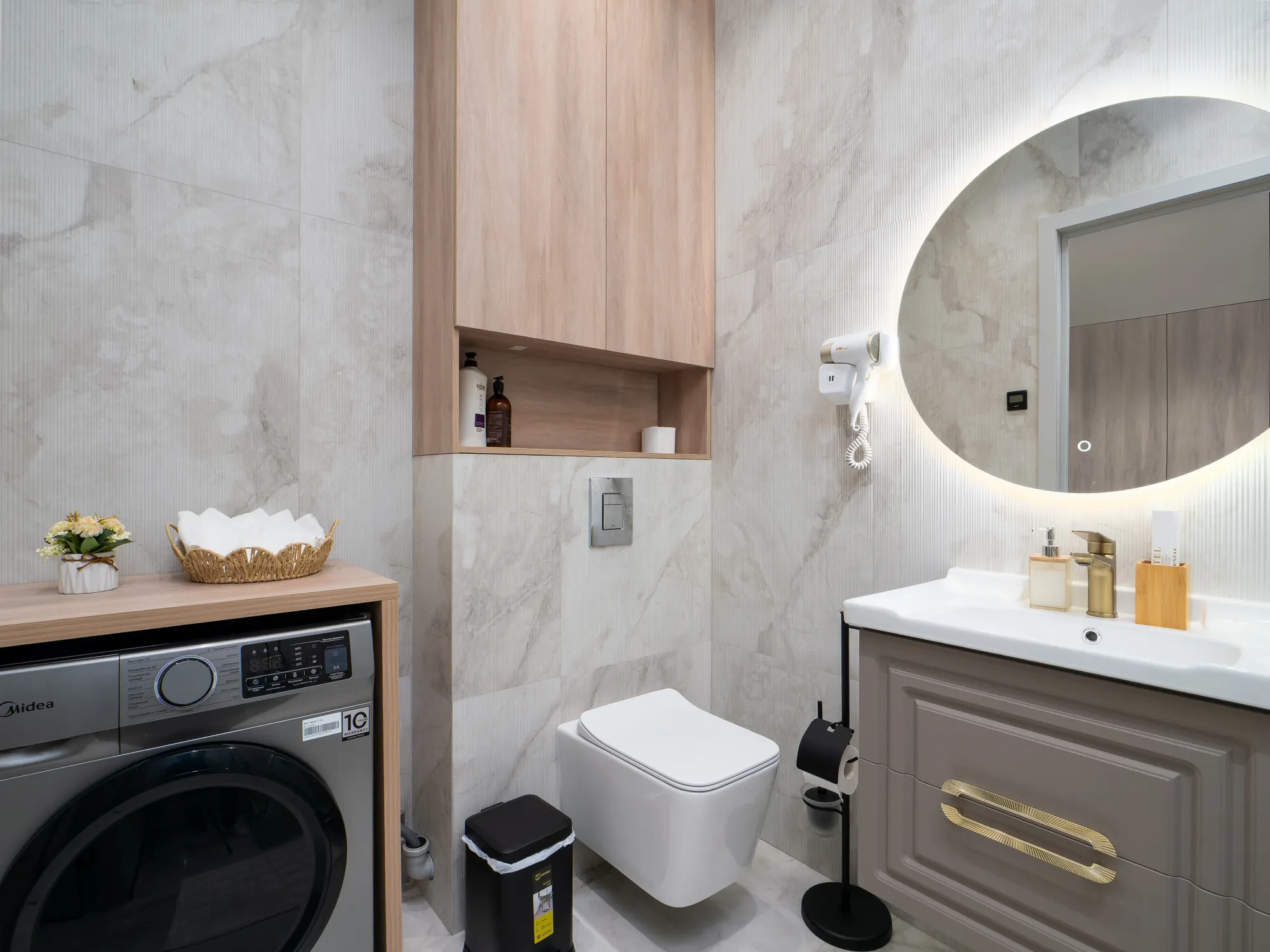 Bathroom with washing machine and vanity storage