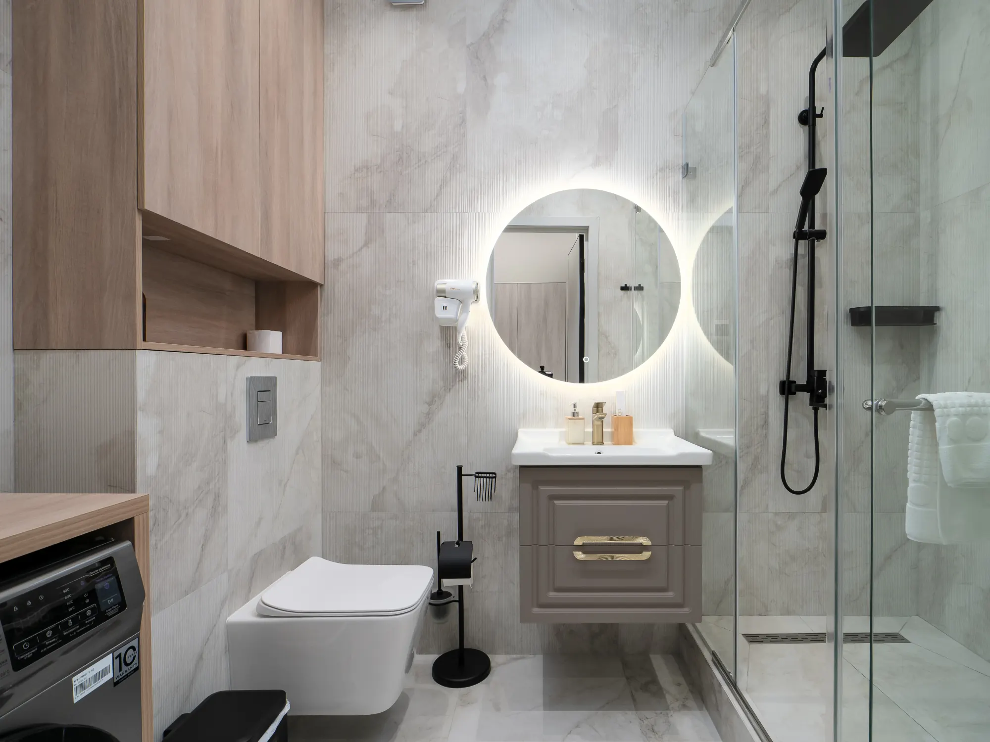 Walk-in glass shower in the marble bathroom